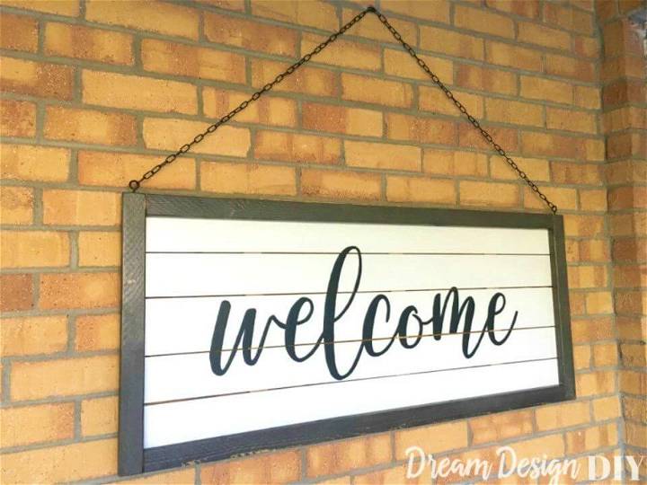 DIY Large Shiplap Welcome Sign, make this porch welcome sign using whtie painted slats and then add a black border or frame all around!