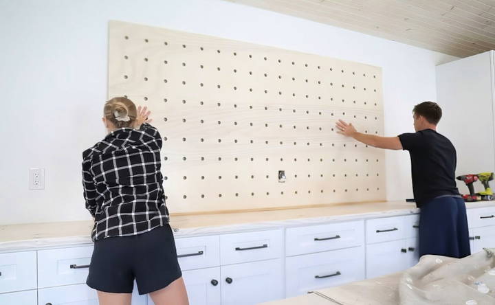 attach the pegboard to the wall