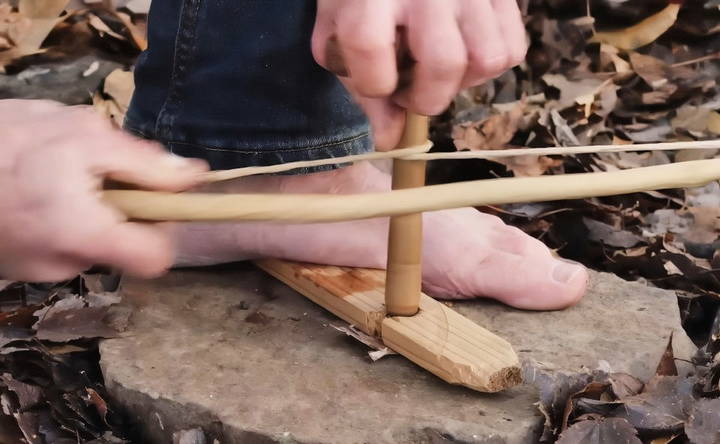 steps to start a fire using a bow drill