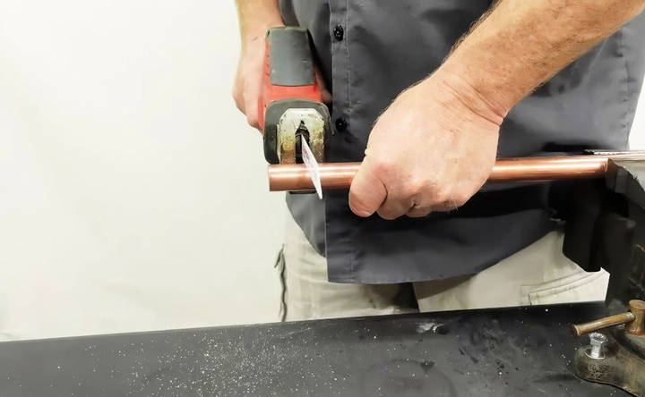 cutting copper pipe using a power hacksaw